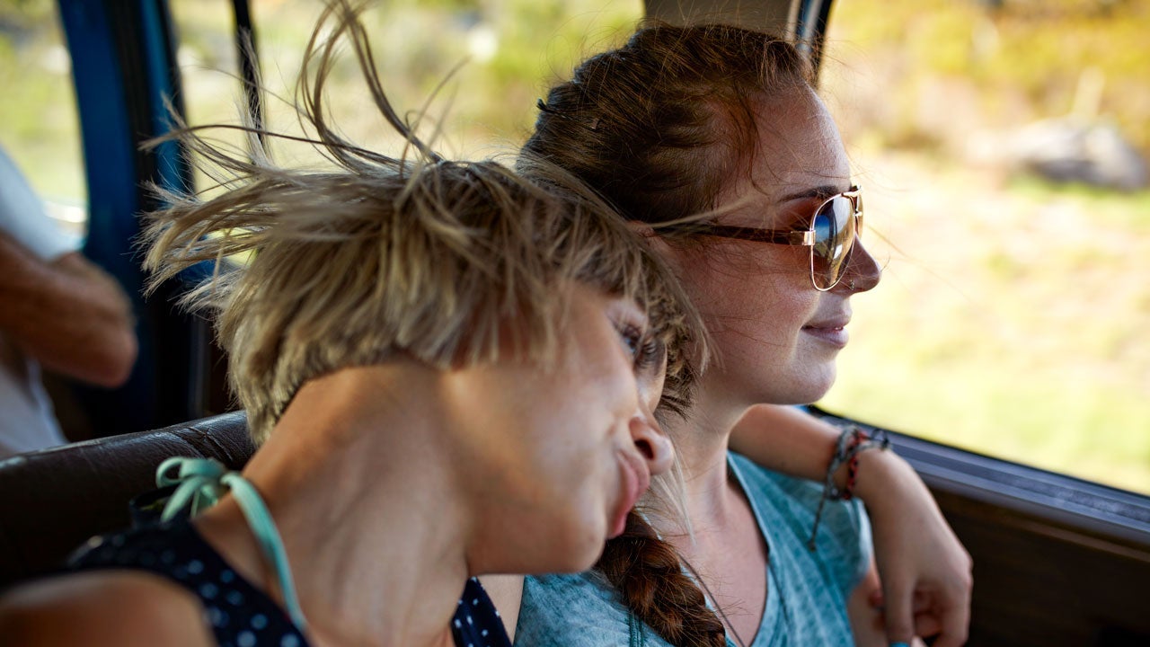 two friends driving on a road trip