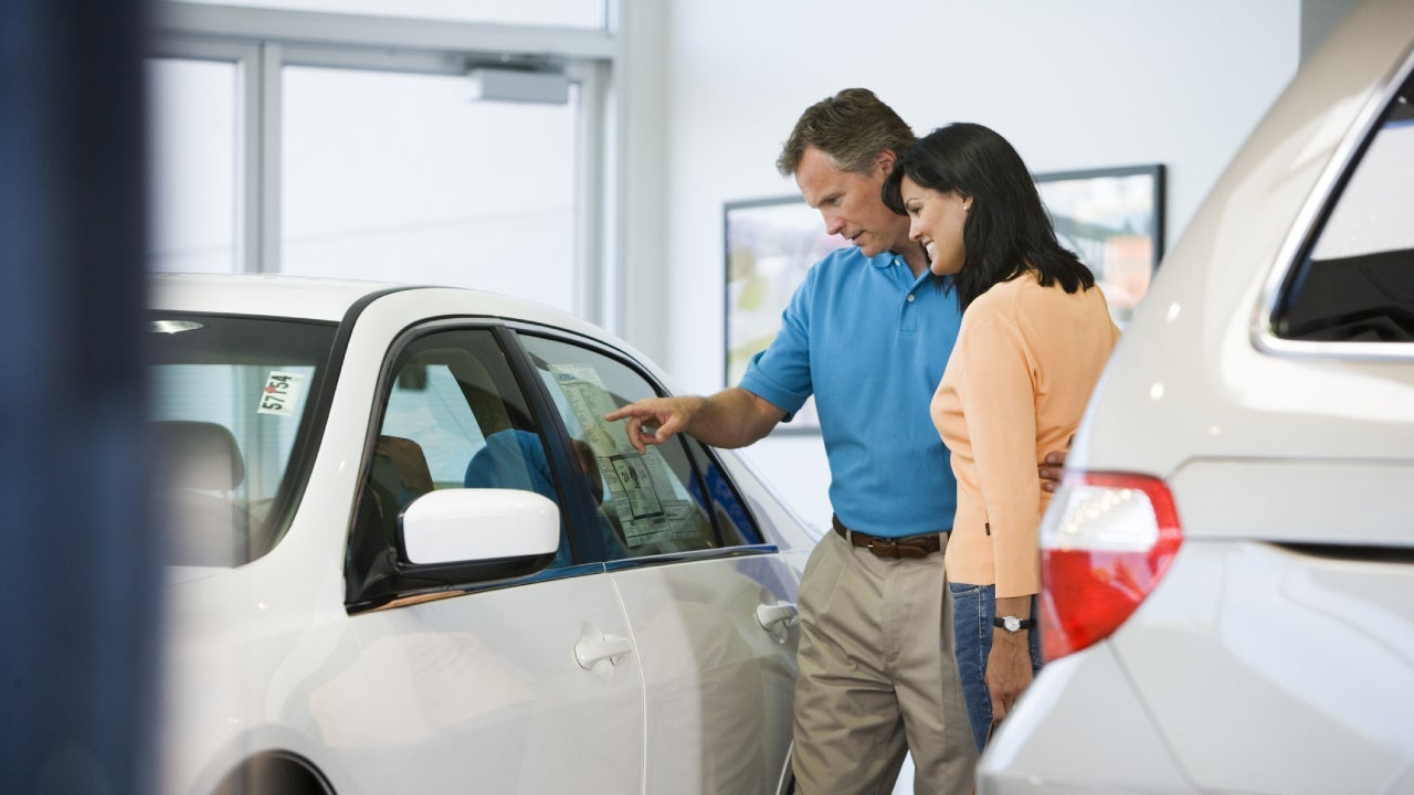 Couple Browsing Car's Sticker Price