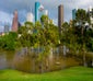 flooded park in texas with buildings in background