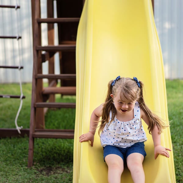 Girl playing outside on slide