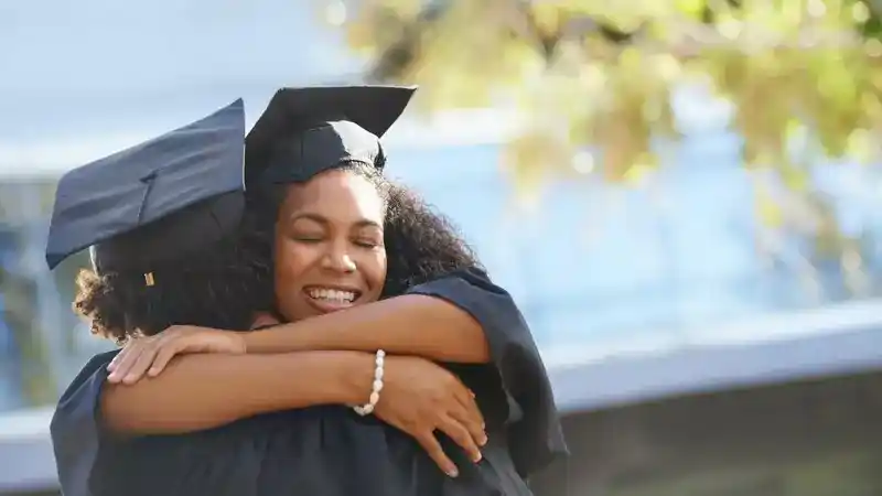 Graduates hugging after ceremony